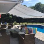 retractable awning covering poolside patio
